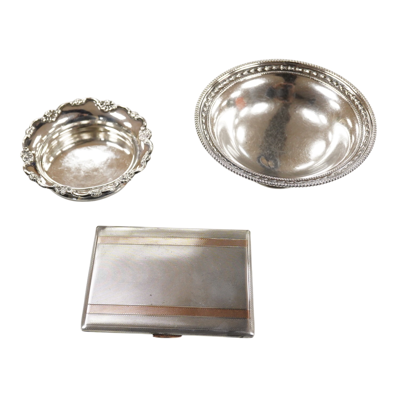 A George V silver pedestal bon bon dish, Sheffield, 1921, diameter 13.2cm, one other earlier silver dish by Josiah Williams & Co, London, 1904 and a silver cigarette case. and a cigarette case, gross 11.5oz.